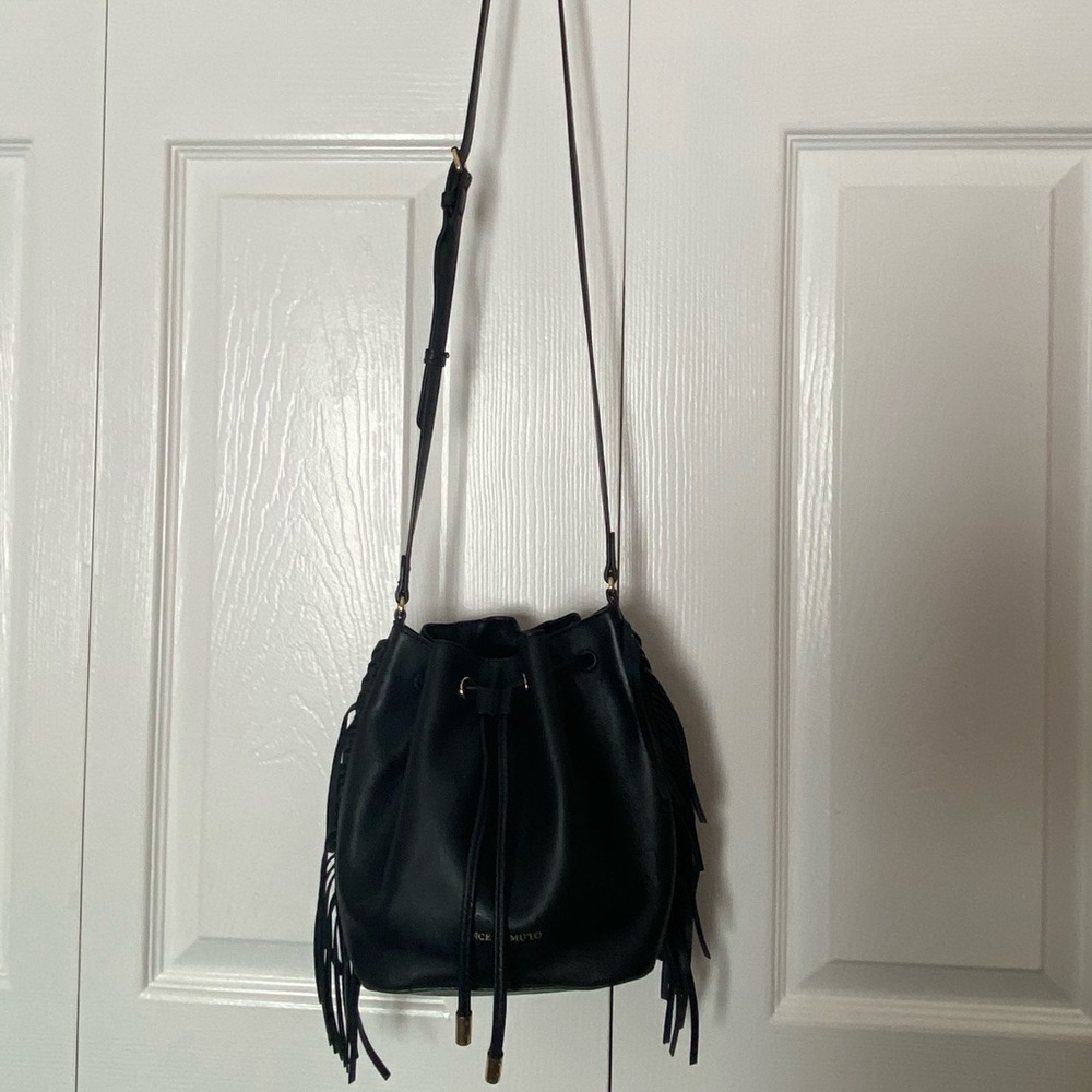 Black leather bucket crossbody bag with fringe
